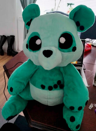 a big plushie of Orbit the Panda, featuring fabric eyes!